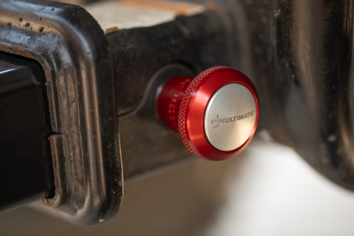 PinUltimate ATV Hitch Pin installed in a 2-inch ATV receiver, red anodized knurled knob with stainless cap